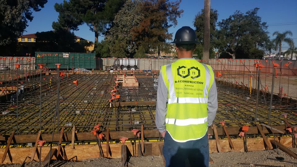 Eli Berkshire-Anderson supervising foundation work at an active job site